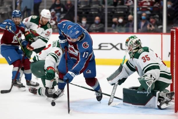 Tyson Jost of the Colorado Avalanche is tripped by Kevin Czuczman of the Minnesota Wild in the second period at Ball Arena on September 30, 2021 in...