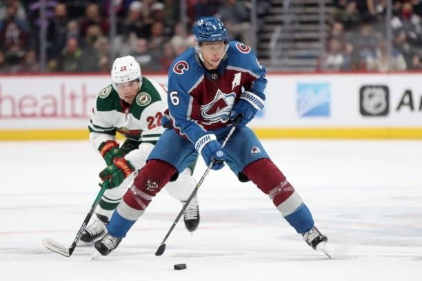 Erik Johnson of the Colorado Avalanche advances the puck against Kevin Fiala of the Minnesota Wild in the second period at Ball Arena on September...