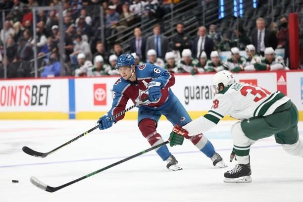 Erik Johnson of the Colorado Avalanche advances the puck against Ryan Hartman of the Minnesota Wild in the second period at Ball Arena on September...