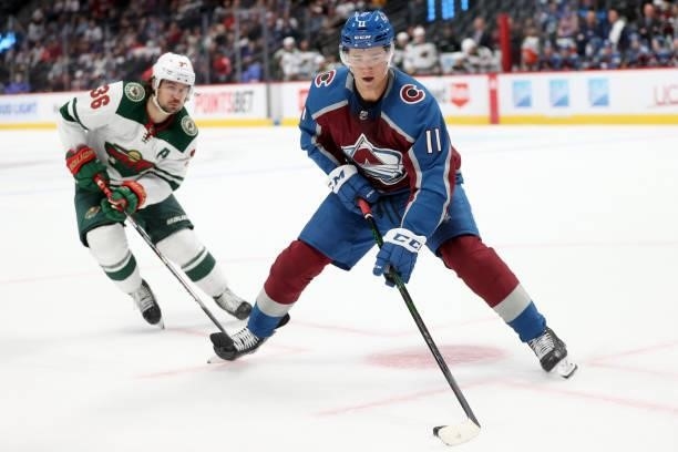 Matt Calvert of the Colorado Avalanche advances the puck against Mats Zuccarello if the Minnesota Wild in the second period at Ball Arena on...