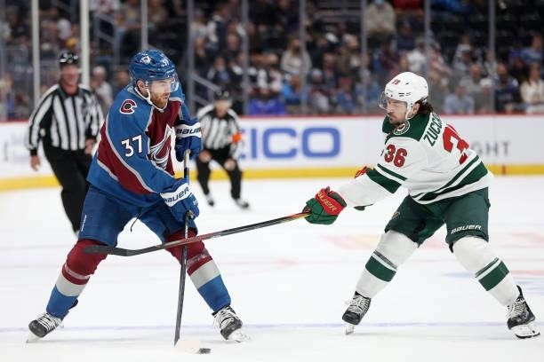Compher of the Colorado Avalanche passes the puck against Mats Zuccarello if the Minnesota Wild in the second period at Ball Arena on September 30,...