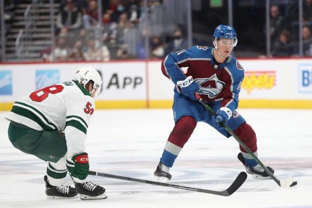 Matt Calvert of the Colorado Avalanche advances the puck against Mason Shaw of the Minnesota Wild in the second period at Ball Arena on September 30,...