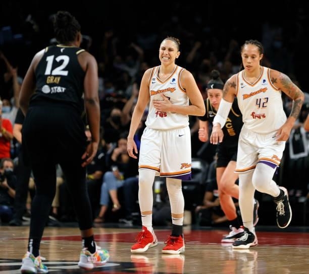 Diana Taurasi of the Phoenix Mercury reacts after taking an elbow from Chelsea Gray of the Las Vegas Aces as she heads up the court with teammate...