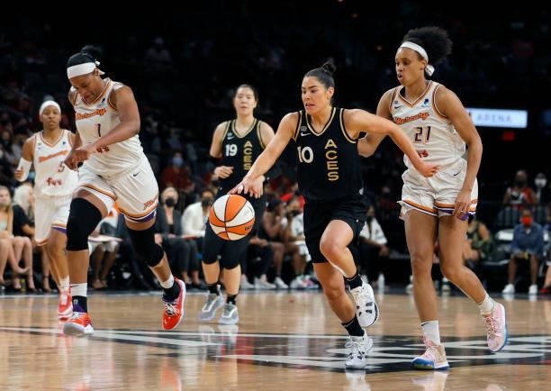 Kelsey Plum of the Las Vegas Aces brings the ball up the court ahead of Brianna Turner and Kia Vaughn of the Phoenix Mercury during Game Two of the...