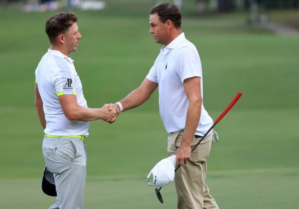 Matt Wallace of England and Nick Watney shakes hands after their round on the 18th green during round two of the Sanderson Farms Championship at...