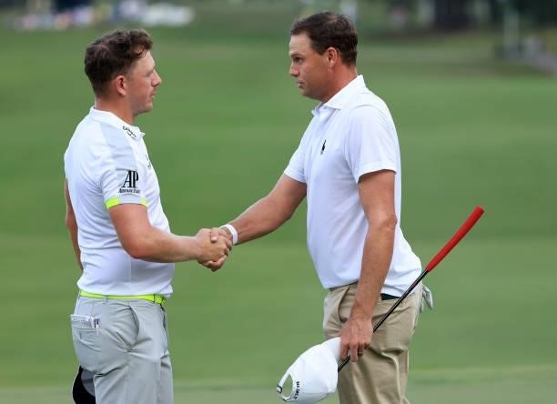 Matt Wallace of England and Nick Watney shakes hands after their round on the 18th green during round two of the Sanderson Farms Championship at...