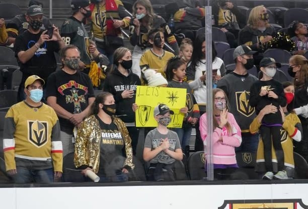 Vegas Golden Knights fans cheer and display signs during warmups prior to a game against the Los Angeles Kings at T-Mobile Arena on October 01, 2021...