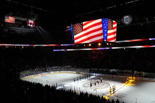 The Vegas Golden Knights and Los Angeles Kings stand on the ice for the national anthem prior to their game at T-Mobile Arena on October 01, 2021 in...