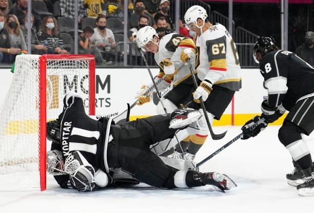 Anze Kopitar of the Los Angeles Kings crashes into goalie Calvin Petersen during the first period of a game against the Vegas Golden Knights at...