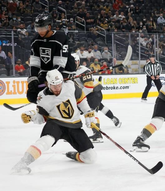 Quinton Byfield of the Los Angeles Kings runs into Daniil Miormanov of the Vegas Golden Knights as he blocks a Kings' shot in the first period of...