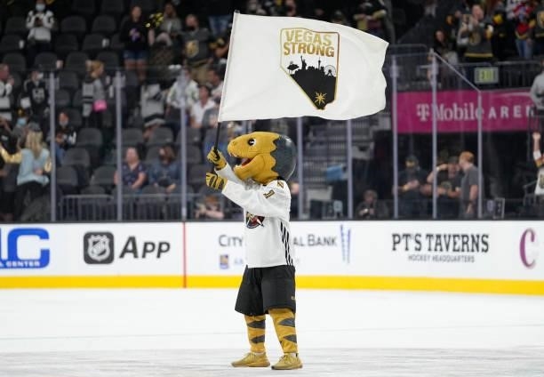 Vegas Golden Knights mascot Chance waves a Vegas Strong flag after a victory over the Los Angeles Kings at T-Mobile Arena on October 01, 2021 in Las...