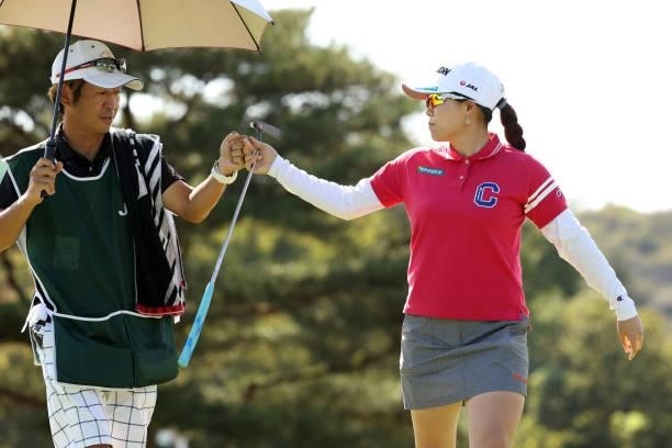 Minami Katsu of Japan fist bumps with her caddie after the birdie on the 8th green during the second round of the 54th Japan Women's Open Golf...