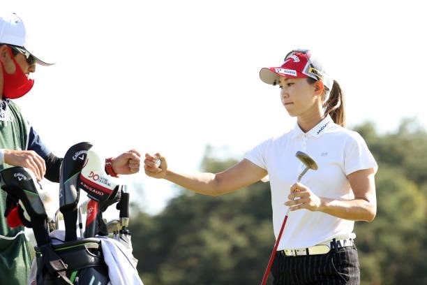 Momoko Ueda of Japan fist bumps with her caddie on the 8th green during the second round of the 54th Japan Women's Open Golf Championship at...
