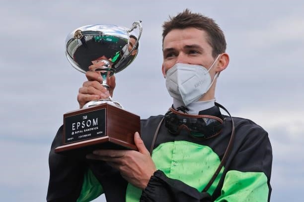Regan Bayliss poses with the Epsom trophy after winning race 8 the TAB Epsom on Private Eye during Sydney Racing at Royal Randwick Racecourse on...