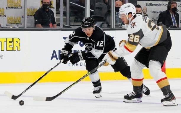 Trevor Moore of the Los Angeles Kings skates with the puck against Mattias Janmark of the Vegas Golden Knights in the third period of their preseason...