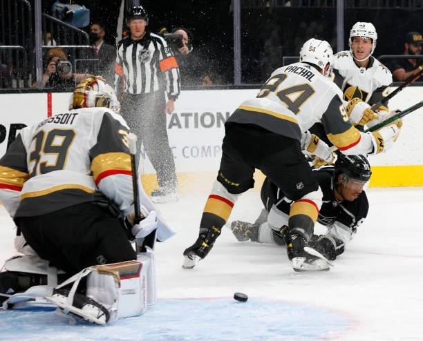 Quinton Byfield of the Los Angeles Kings shoots against Laurent Brossoit of the Vegas Golden Knights as Brayden Pachal and Peter DiLiberatore of the...