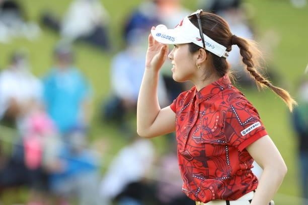 Yuna Nishimura of Japan applauds fans after holing out with the birdie on the 18th green during the second round of the 54th Japan Women's Open Golf...