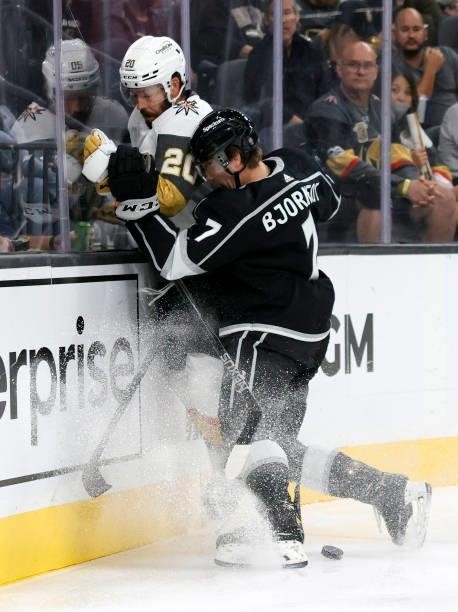 Tobias Bjornfot of the Los Angeles Kings checks Chandler Stephenson of the Vegas Golden Knights into the boards in the second period of their...