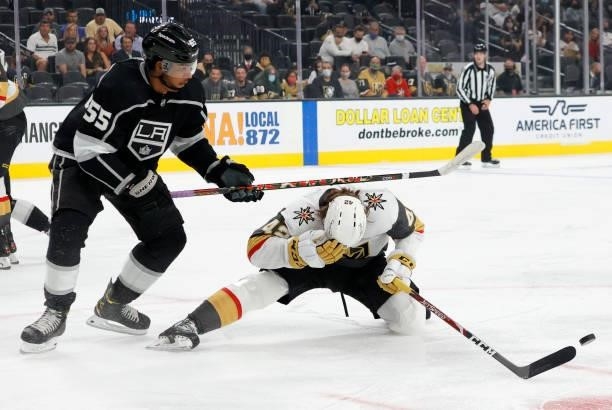 Quinton Byfield of the Los Angeles Kings runs into Daniil Miormanov of the Vegas Golden Knights as he blocks a Kings' shot in the first period of...