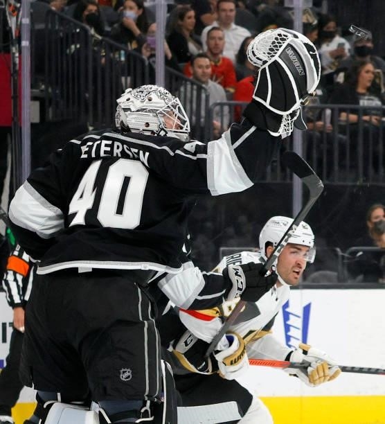 Calvin Petersen of the Los Angeles Kings bats the puck out of the air in front of William Carrier of the Vegas Golden Knights in the second period of...