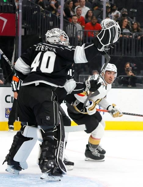 Calvin Petersen of the Los Angeles Kings bats the puck out of the air in front of William Carrier of the Vegas Golden Knights in the second period of...