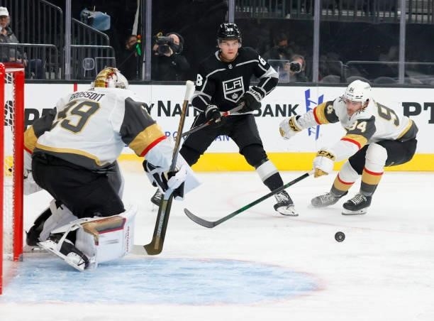 Samuel Fagemo of the Los Angeles Kings passes under pressure from Brayden Pachal of the Vegas Golden Knights as Laurent Brossoit of the Golden...