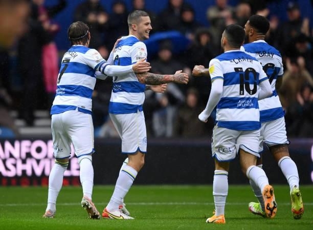 Lyndon Dykes celebrates with teammates Stefan Johansen, Andre Gray and Ilias Chair of Queens Park Rangers after scoring their team's first goal...