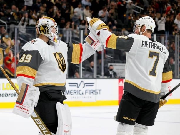 Laurent Brossoit of the Vegas Golden Knights high-fives Alex Pietrangelo as they celebrate the team's 4-0 victory over the Los Angeles Kings in their...