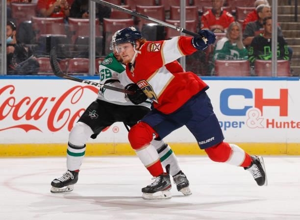 Owen Tippett of the Florida Panthers skates past Dawson Barteaux of the Dallas Stars during a preseason game at the FLA Live Arena on October 1, 2021...