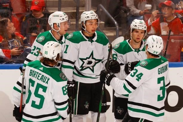 Teammates congratulate Jason Robertson of the Dallas Stars after he scored a third period goal against the Florida Panthers during a preseason game...