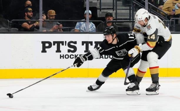 Lias Andersson of the Los Angeles Kings skates with the puck against Nicolas Hague of the Vegas Golden Knights in the third period of their preseason...