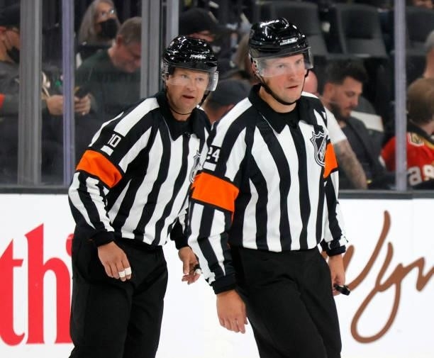 Referees Graham Skilliter and Kyle Rehman officiate a preseason game between the Los Angeles Kings and the Vegas Golden Knights at T-Mobile Arena on...