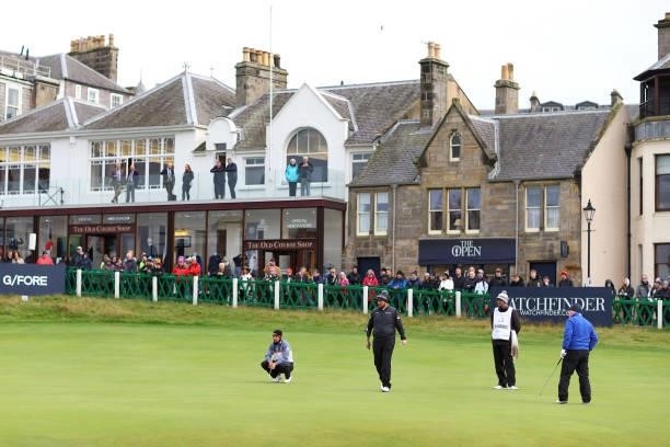 Spectators look on as Shane Lowry of Ireland and Rafa Cabrera Bello of Spain line up a putt on the 18th green during Day Three of The Alfred Dunhill...