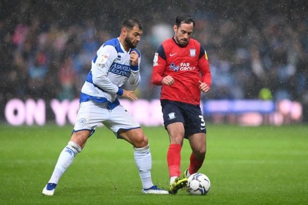 Charlie Austin of Queens Park Rangers and Greg Cunningham of Preston North End clash during the Sky Bet Championship match between Queens Park...