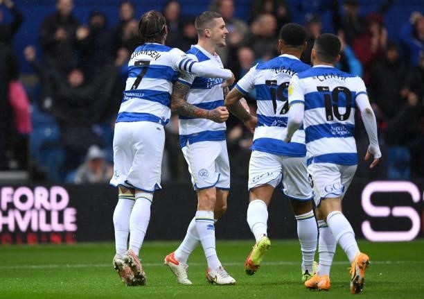 Lyndon Dykes celebrates with teammates Stefan Johansen, Andre Gray and Ilias Chair of Queens Park Rangers after scoring their team's first goal...
