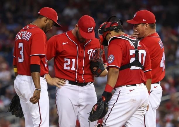 Alcides Escobar, Tanner Rainey, Keibert Ruiz and Jim Hickey Washington Nationals meet on the mound in the eighth inning against the Boston Red Sox at...