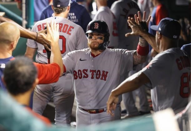 Christian Vazquez of the Boston Red Sox celebrates in the dugout after scoring against the Washington Nationals in the ninth inning at Nationals Park...