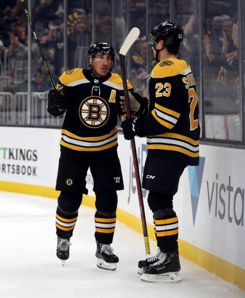 Brad Marchand of the Boston Bruins celebrates with Jack Studnicka after scoring a goal against the New York Rangers during the first period of the...