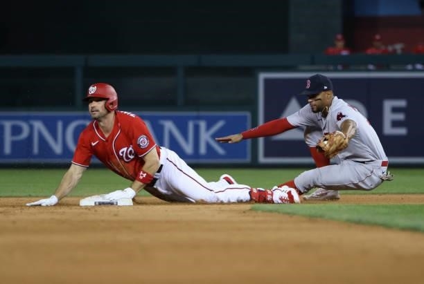 Ryan Zimmerman of the Washington Nationals slides safely into second against Xander Bogaerts of the Boston Red Sox after hitting a double in the...