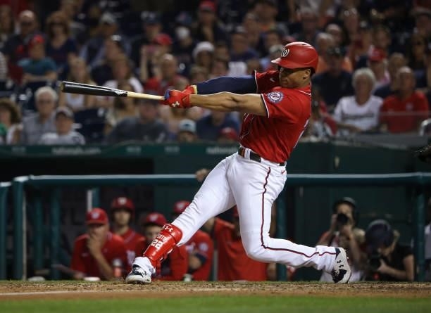Juan Soto of the Washington Nationals hits a sacrifice fly in the eighth inning against the Boston Red Sox at Nationals Park on October 02, 2021 in...