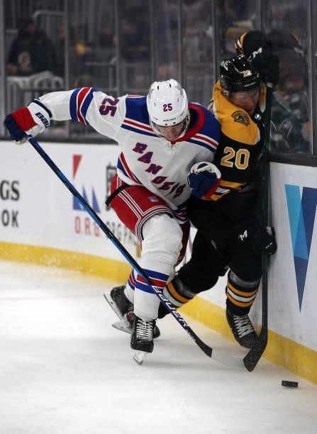 Libor Hajek of the New York Rangers checks Curtis Lazar of the Boston Bruins into the boards during the first period of the preseason game at TD...