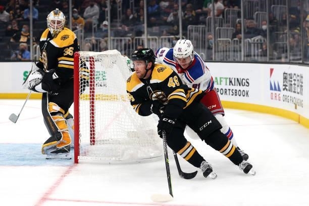 Matt Grzelcyk of the Boston Bruins skates against Sammy Blais of the New York Rangers during the second period of the preseason game at TD Garden on...