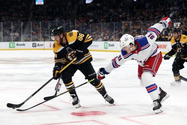 Sammy Blais of the New York Rangers defends David Pastrnak of the Boston Bruins during the third period of the preseason game at TD Garden on October...