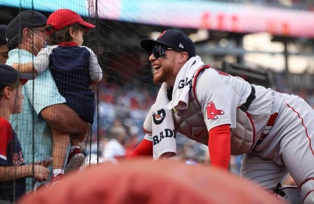 Catcher Christian Vazquez of the Boston Red Sox greets a young fan before playing the Washington Nationals at Nationals Park on October 02, 2021 in...
