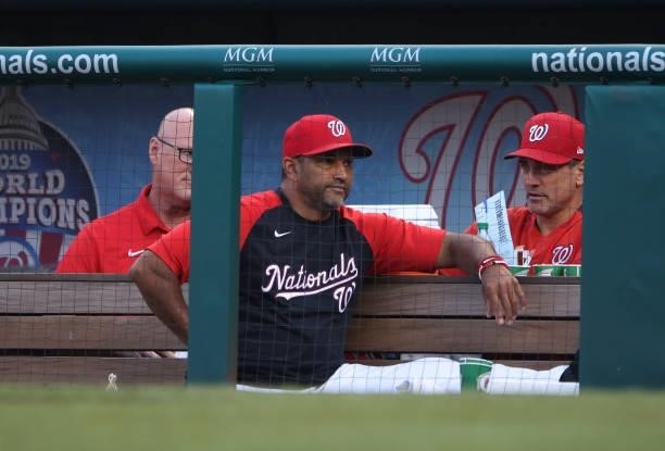 Washington Nationals manager Dave Martinez watches from the dugout as the Nationals play the Boston Red Sox at Nationals Park on October 02, 2021 in...