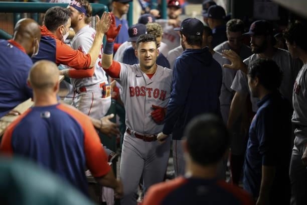 Jose Iglesias of the Boston Red Sox celebrates in the dugout after scoring against the Washington Nationals in the ninth inning at Nationals Park on...