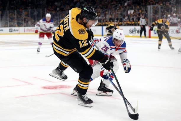 Libor Hajek of the New York Rangers and Craig Smith of the Boston Bruins battle for control of the puck during the third period of the preseason game...