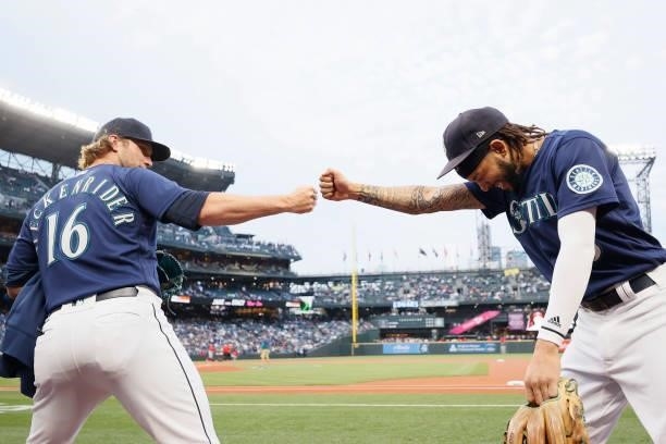 Drew Steckenrider and J.P. Crawford of the Seattle Mariners bump fists before the game against the Los Angeles Angels at T-Mobile Park on October 02,...