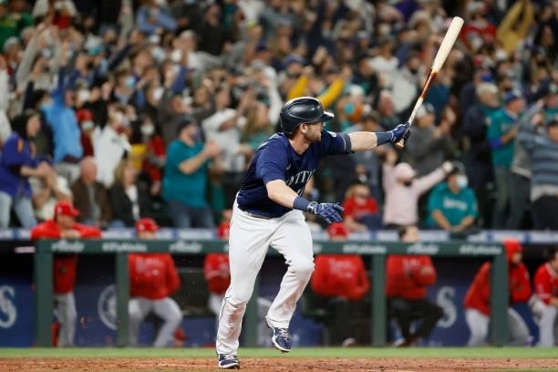 Mitch Haniger hits a two-run RBI single during the eighth inning against the Los Angeles Angels at T-Mobile Park on October 02, 2021 in Seattle,...