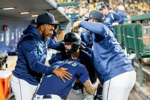 Mitch Haniger of the Seattle Mariners reacts with Justin Dunn, J.P. Crawford and Kyle Lewis after Haniger's two run home run against the Los Angeles...